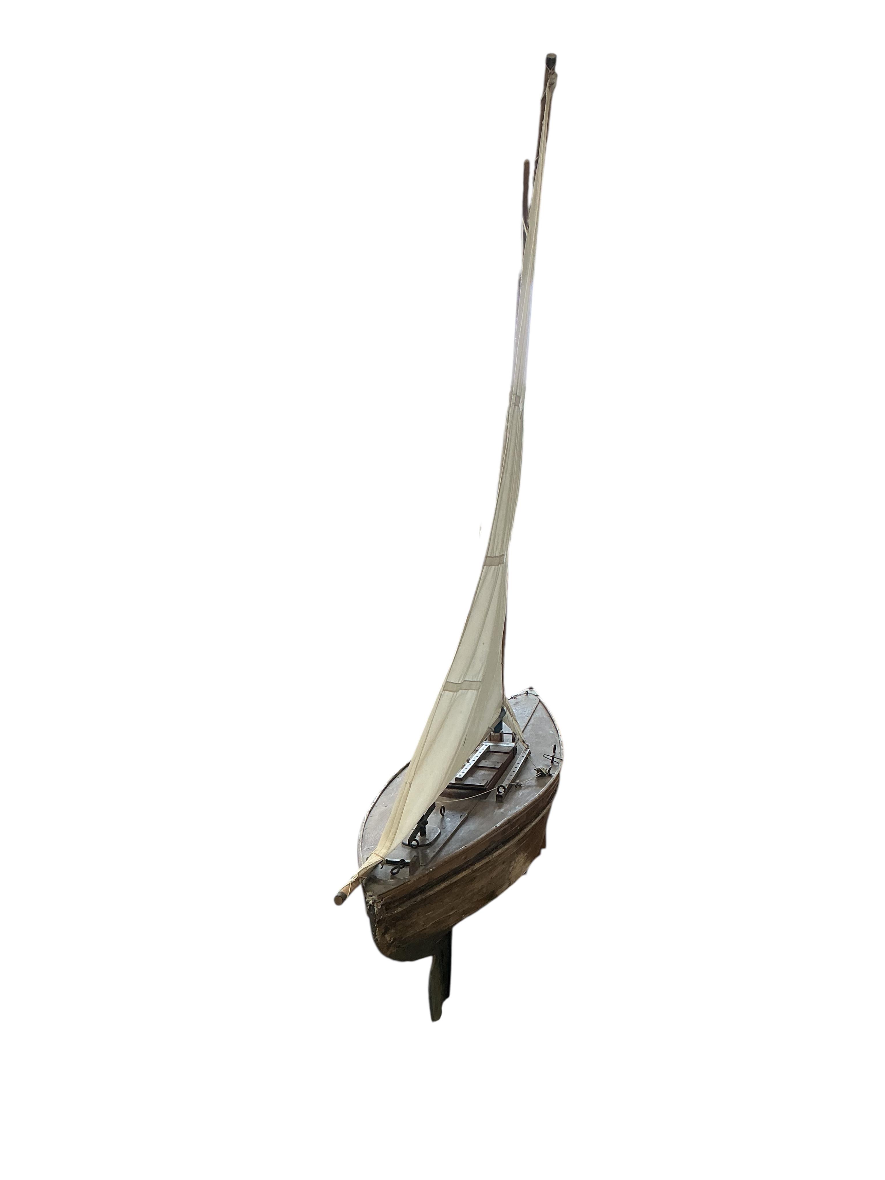 An early 20th century pond yacht with carvel hull on later stand, height including stand 146cm